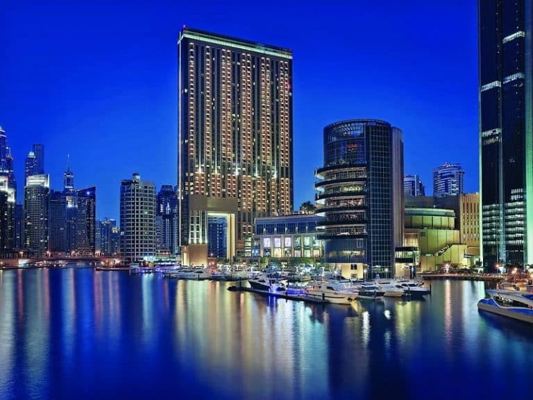 The address Dubai marina exterior view night overlooking marina
