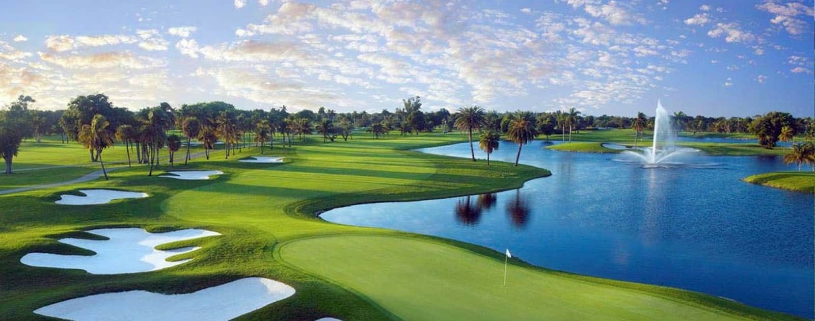 The Blue Monster Golf Course at Trump National Doral Miami, featuring palm-lined fairways and water hazards under clear Florida skies