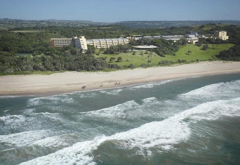 Aerial view of coastline and Wild Coast Sun
